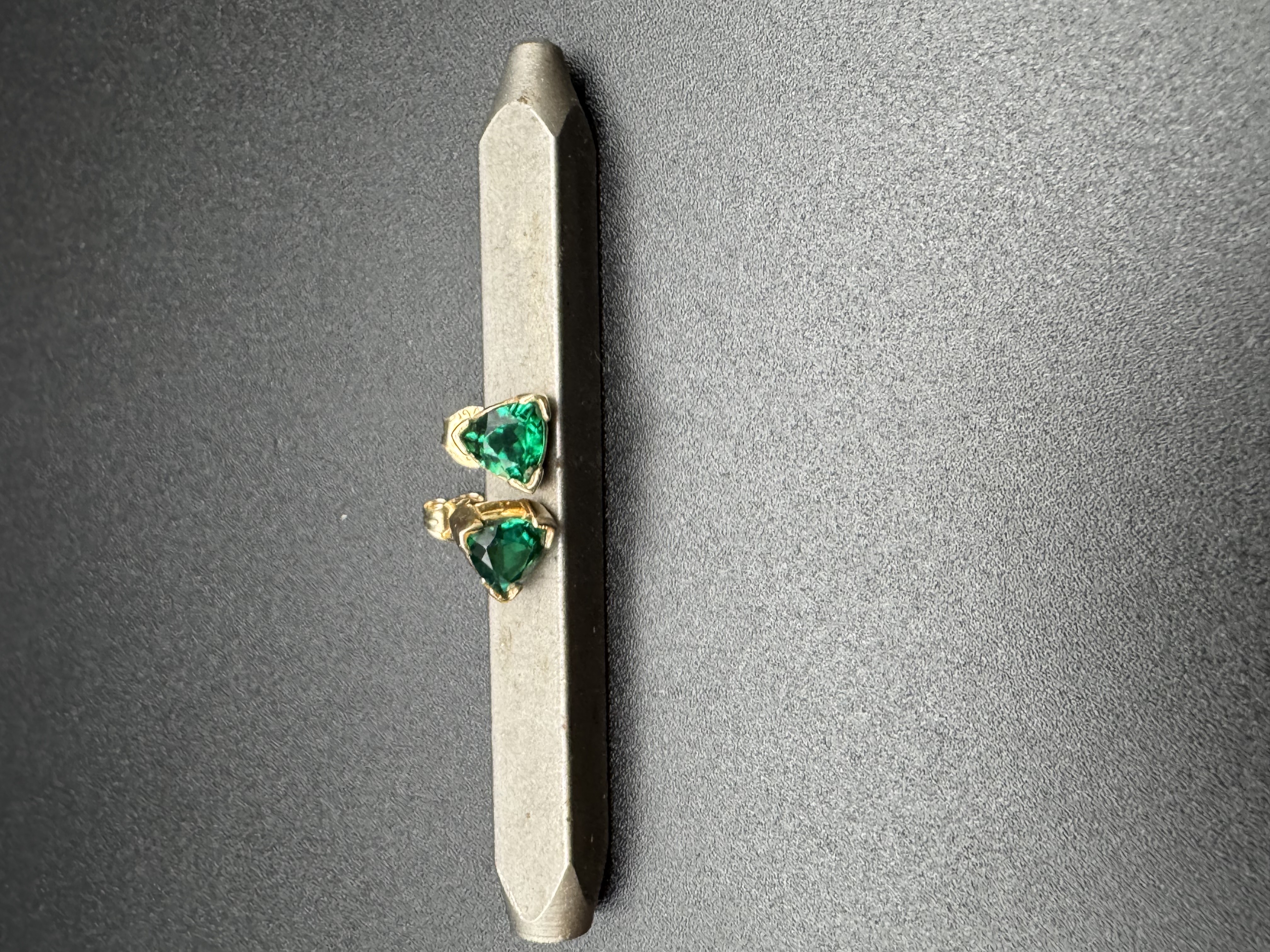 Trillion cut emerald stud earrings in 14k gold